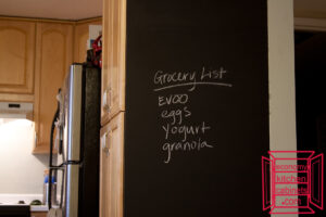 A kitchen chalkboard with a grocery list